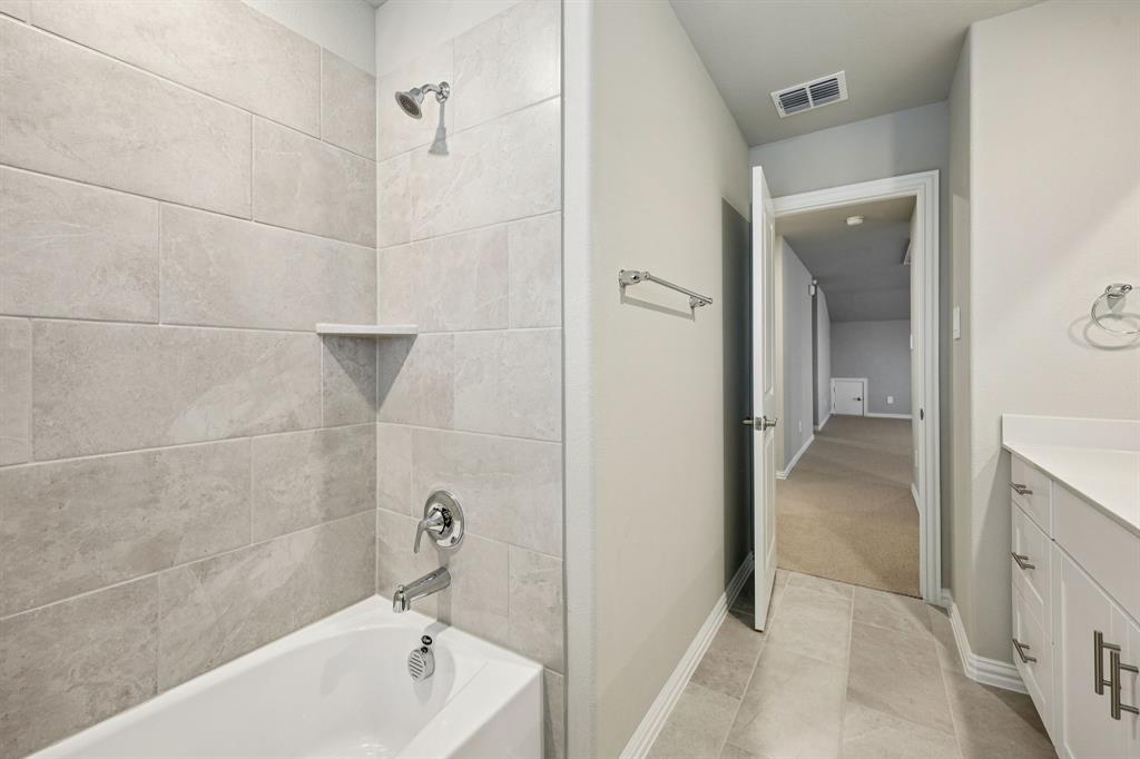 1721 Arches Road Anna, TX 75409 - Photo 34 of 39 a bathroom with a bathtub and shower