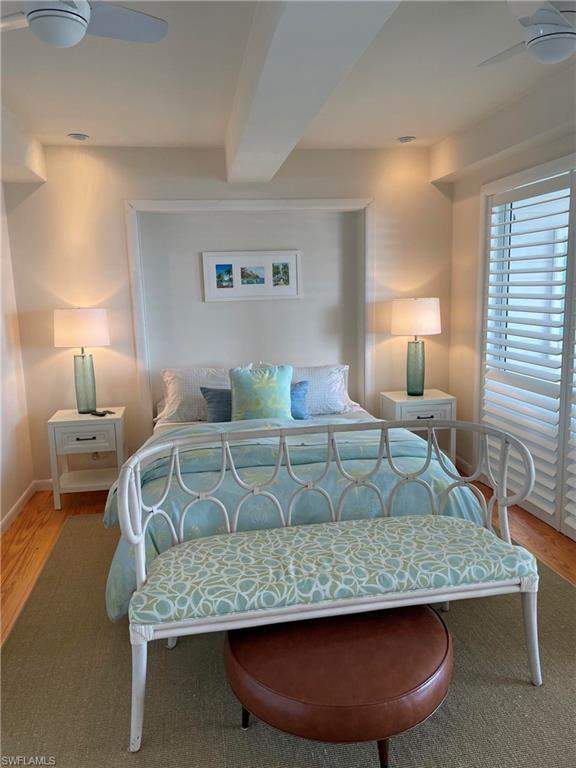 105 Useppa Bokeelia, FL 33922 - Photo 20 of 39 a bedroom with a bed a lamp and a large window