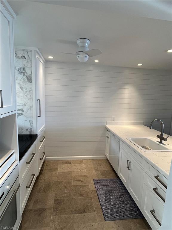 105 Useppa Bokeelia, FL 33922 - Photo 8 of 39 a bathroom with a granite countertop sink a mirror and a bathtub