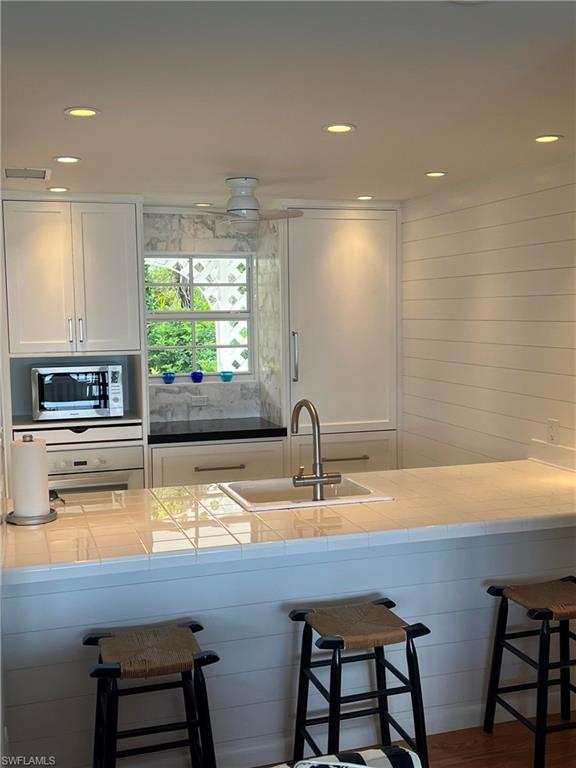 105 Useppa Bokeelia, FL 33922 - Photo 9 of 39 a kitchen with a sink cabinets and window