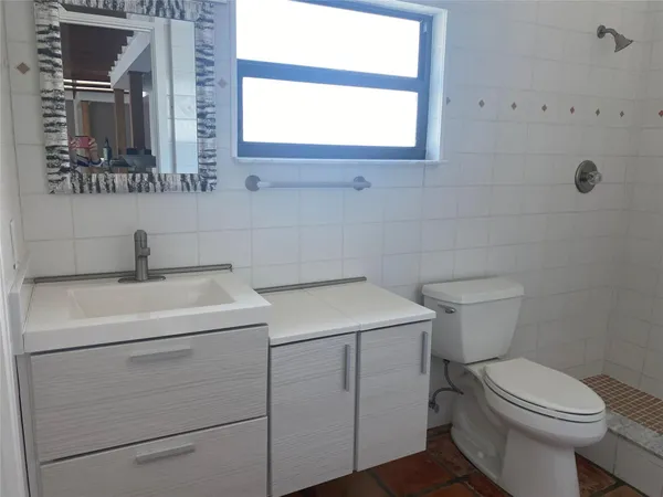 a bathroom with a sink toilet and mirror