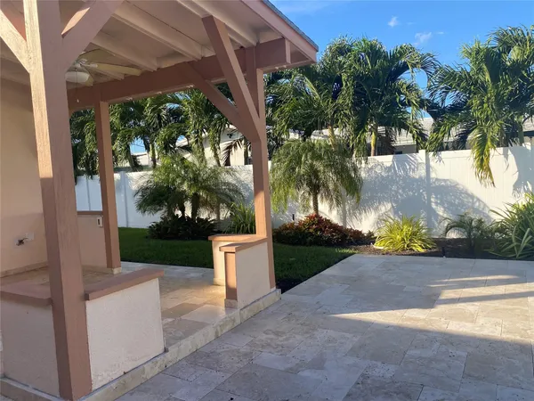 a view of a house with a yard and tree s