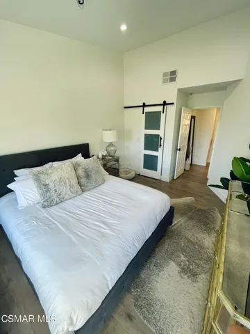a bedroom with a bed and cabinets
