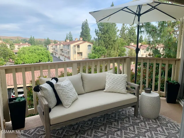 a balcony view with a seating space