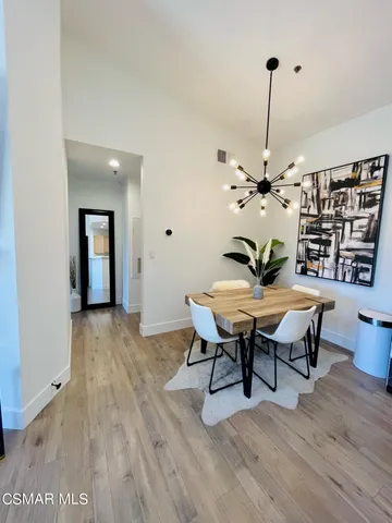 a view of a workspace with furniture and wooden floor