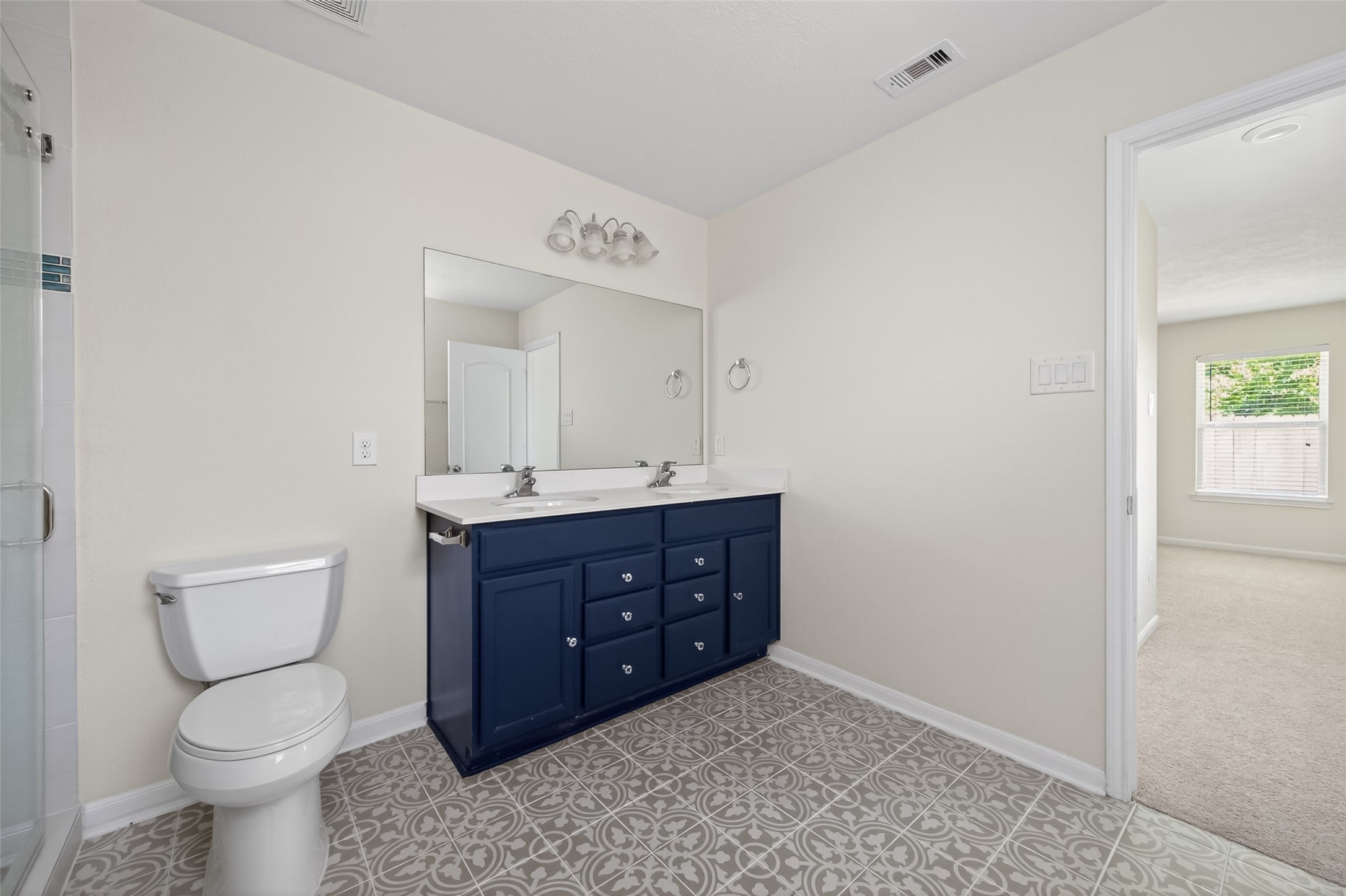 2754 Cayden Creek Way Conroe, TX 77304 - Photo 27 of 40 a bathroom with a toilet a sink and mirror