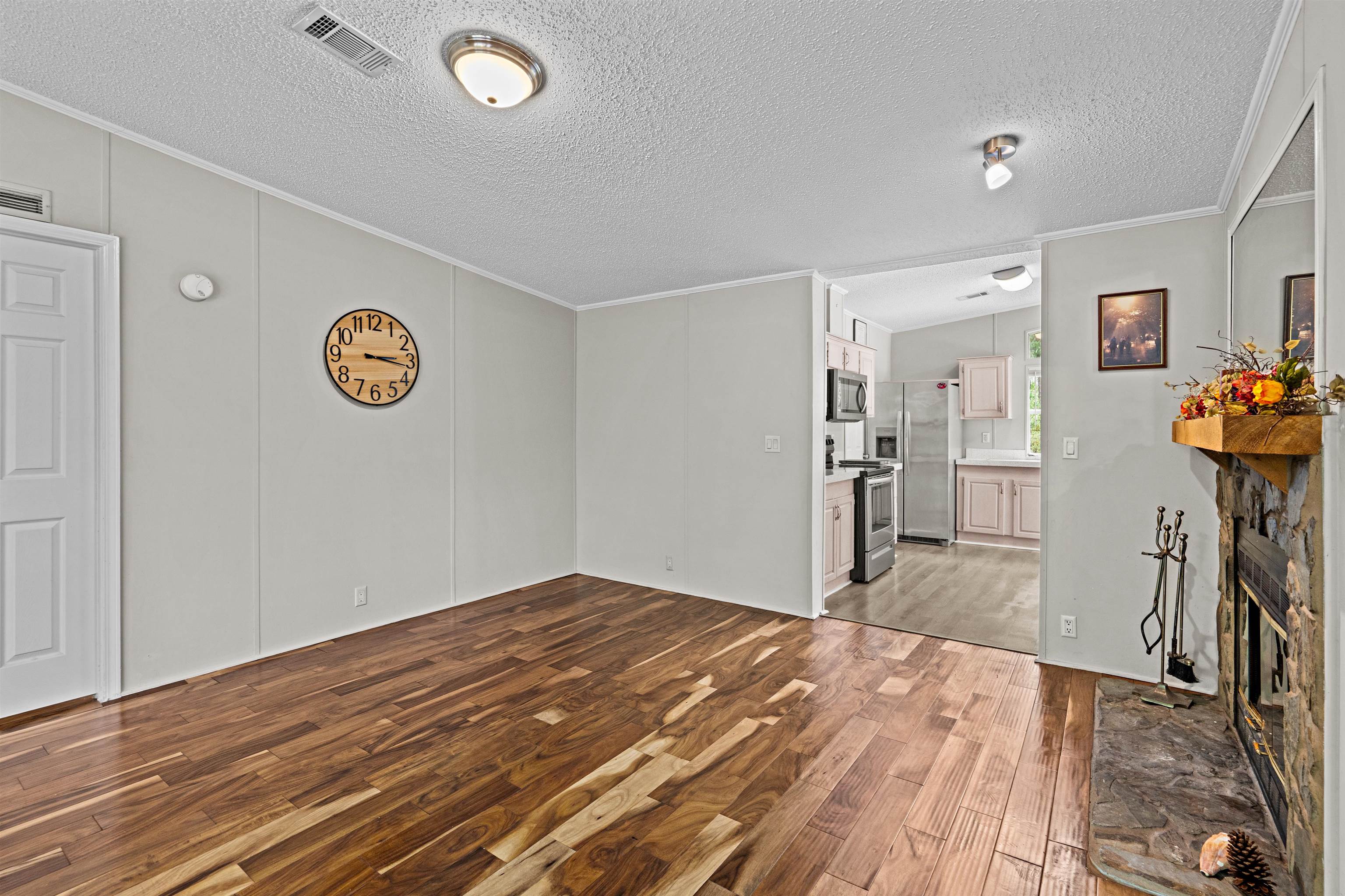2130 Carter Road St. Augustine, FL 32084 - Photo 13 of 67 Unfurnished living room with crown molding, light wood finished floors, and a fireplace
