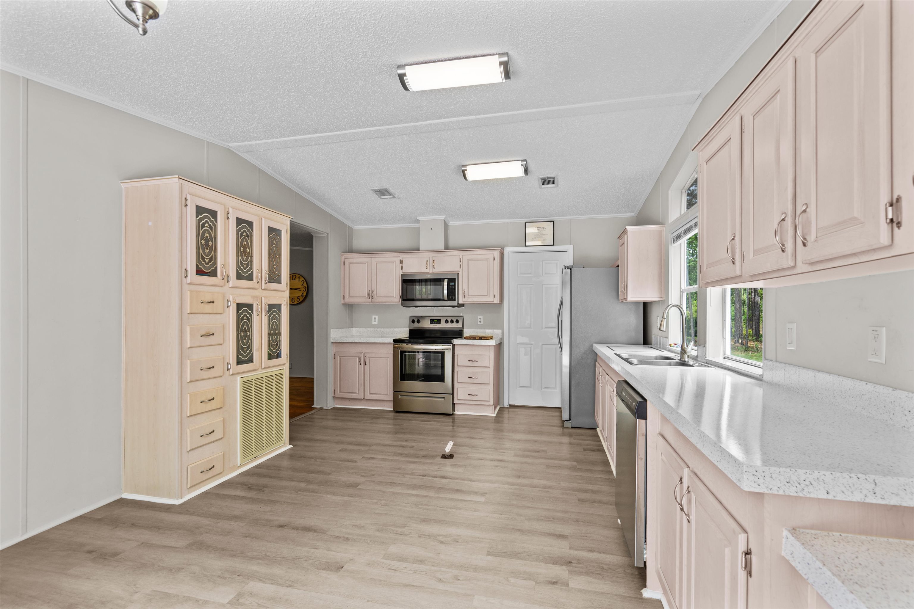 2130 Carter Road St. Augustine, FL 32084 - Photo 16 of 67 Kitchen featuring stainless steel appliances, light wood finish cabinetry, ornamental molding, and light wood-style floors