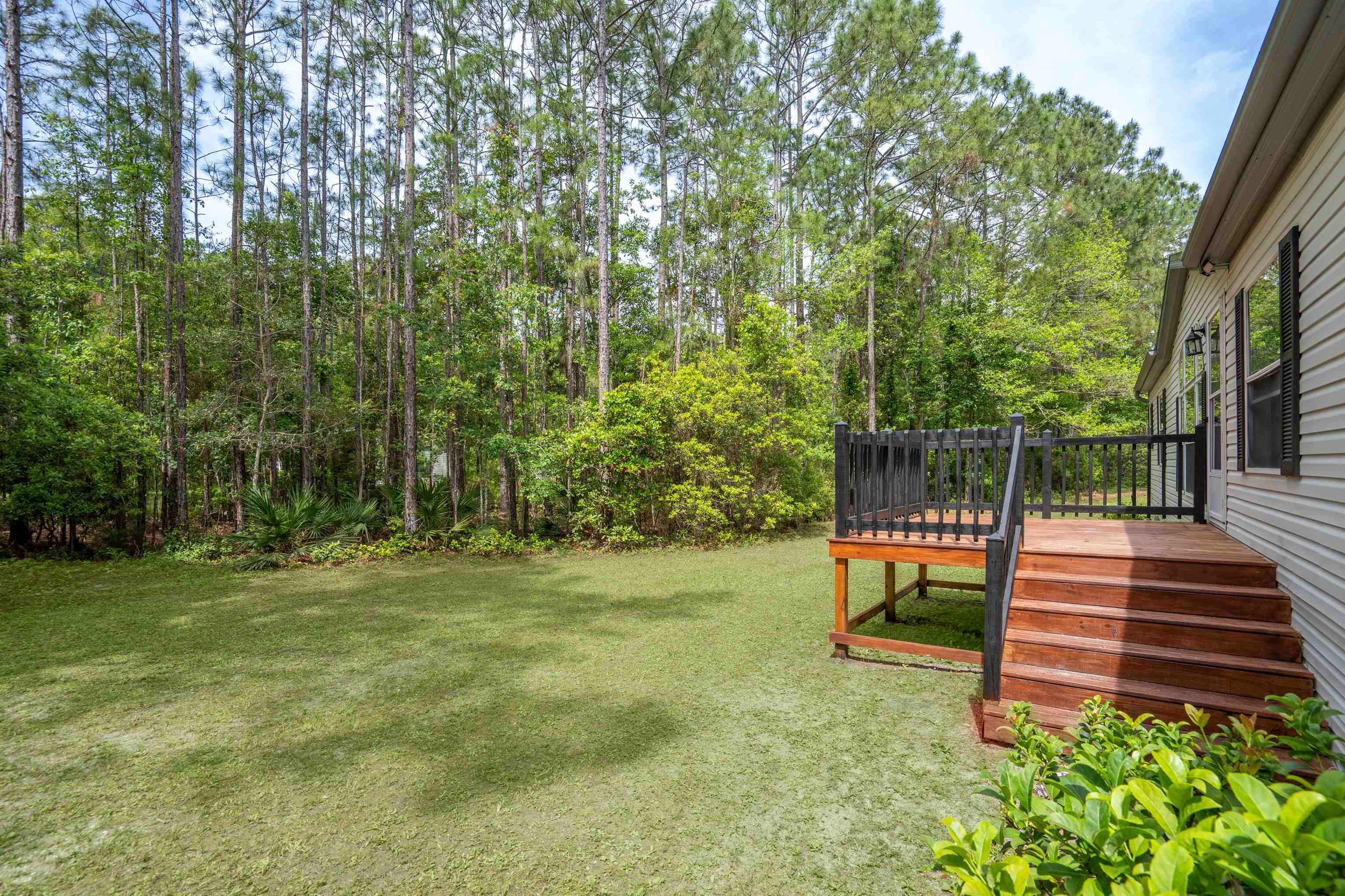 2130 Carter Road St. Augustine, FL 32084 - Photo 3 of 67 View of grassy yard featuring a wooden deck