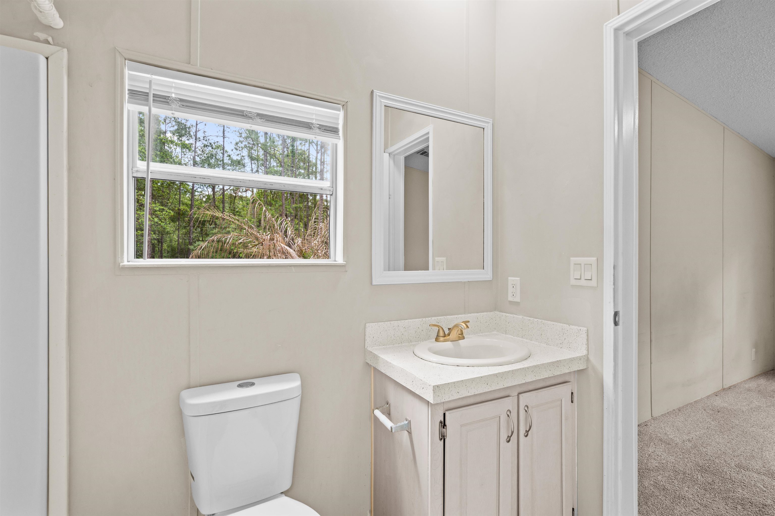 2130 Carter Road St. Augustine, FL 32084 - Photo 32 of 67 Half bathroom with vanity and toilet