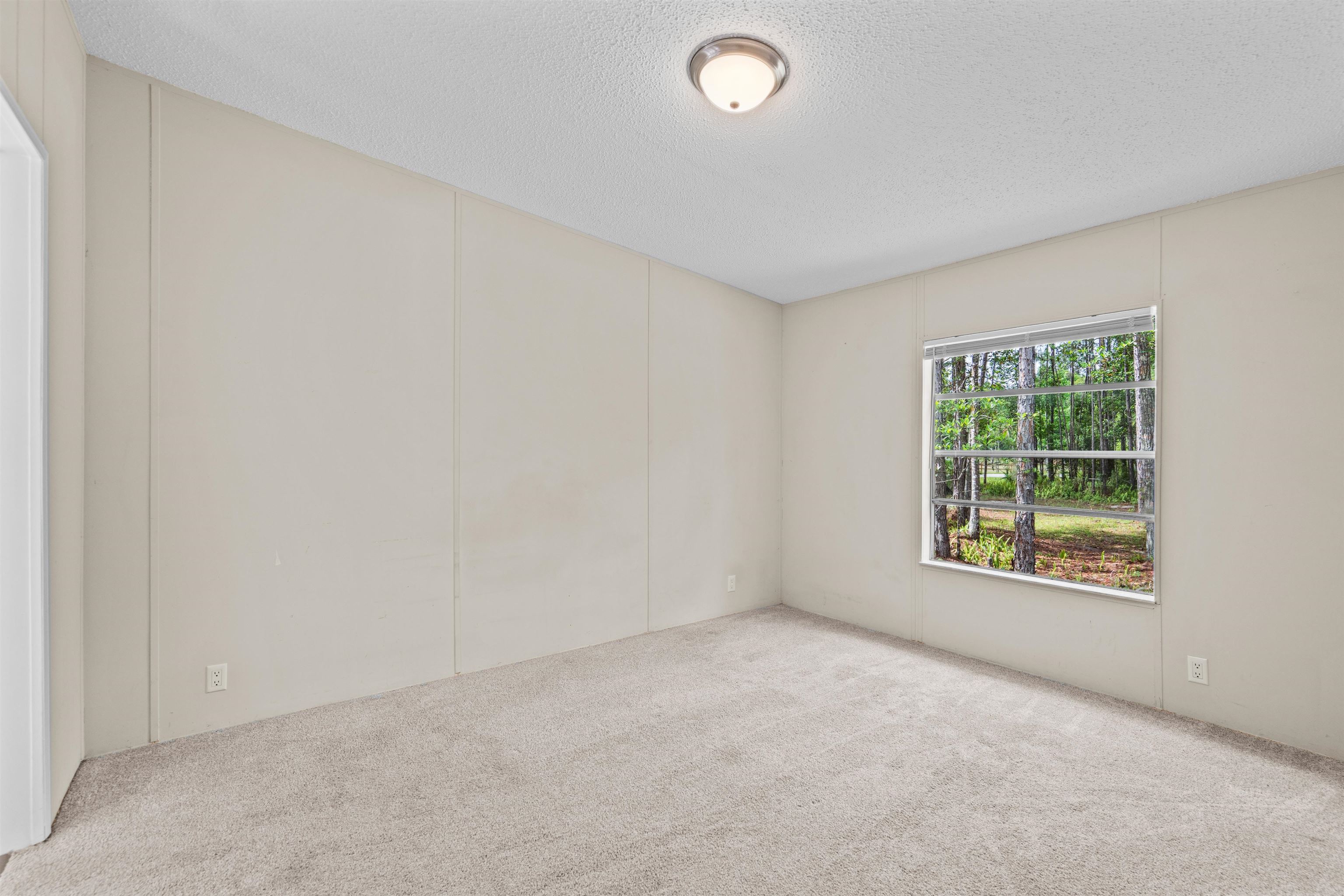 2130 Carter Road St. Augustine, FL 32084 - Photo 33 of 67 Carpeted spare room with a decorative wall and a textured ceiling