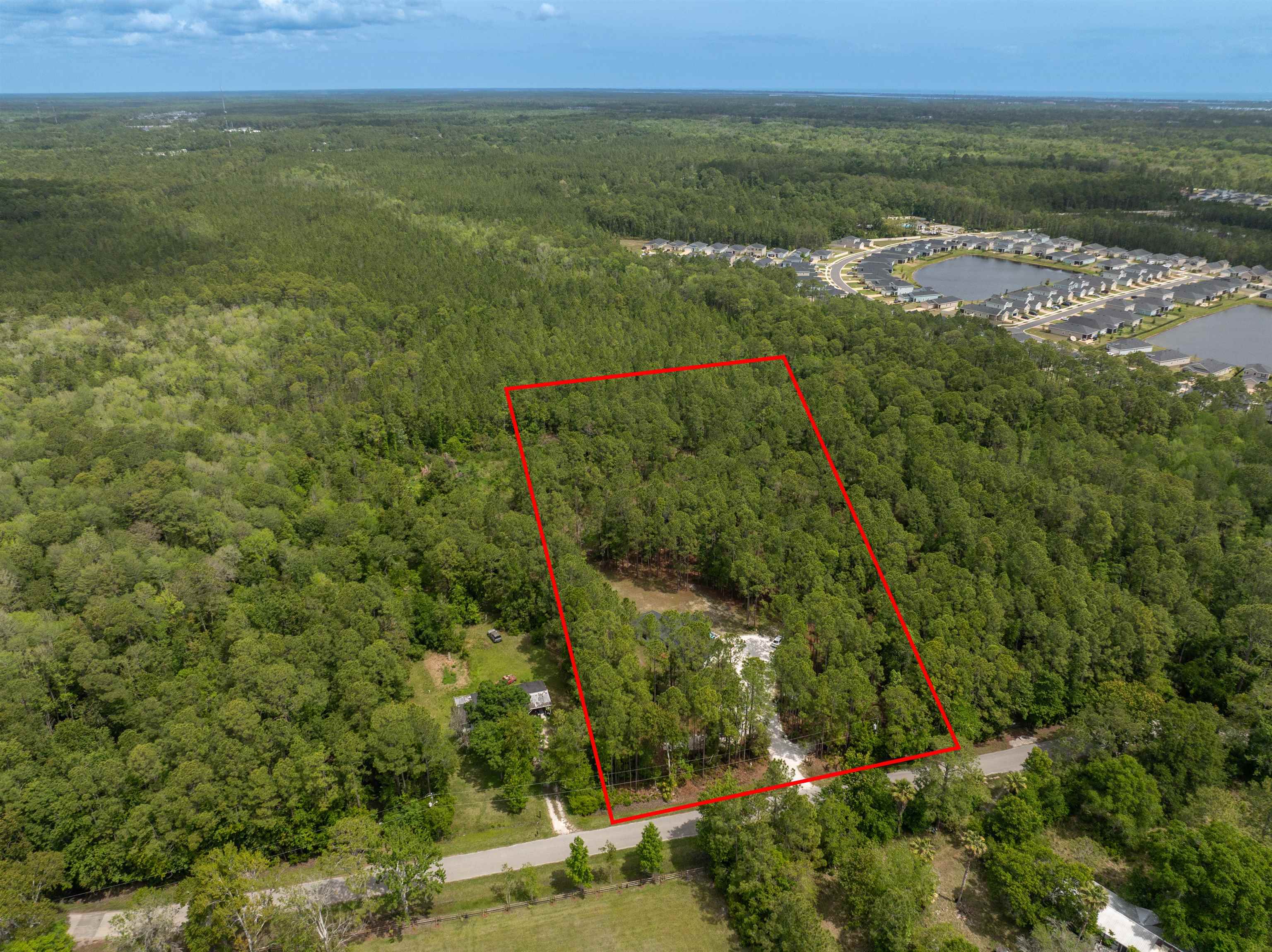 2130 Carter Road St. Augustine, FL 32084 - Photo 55 of 67 Aerial view of property and surrounding area with a heavily wooded area and property parcel outlined