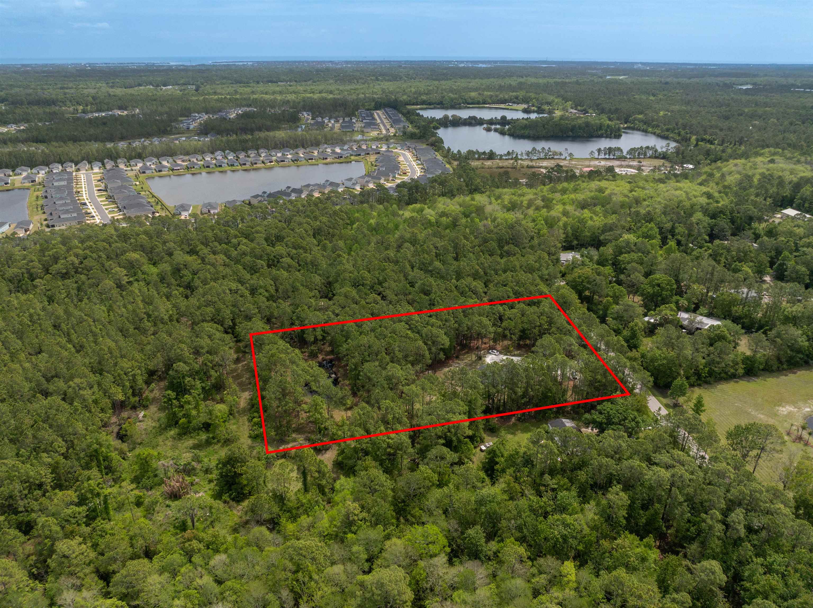 2130 Carter Road St. Augustine, FL 32084 - Photo 58 of 67 Aerial view of property and surrounding area with a large body of water and property boundaries highlighted