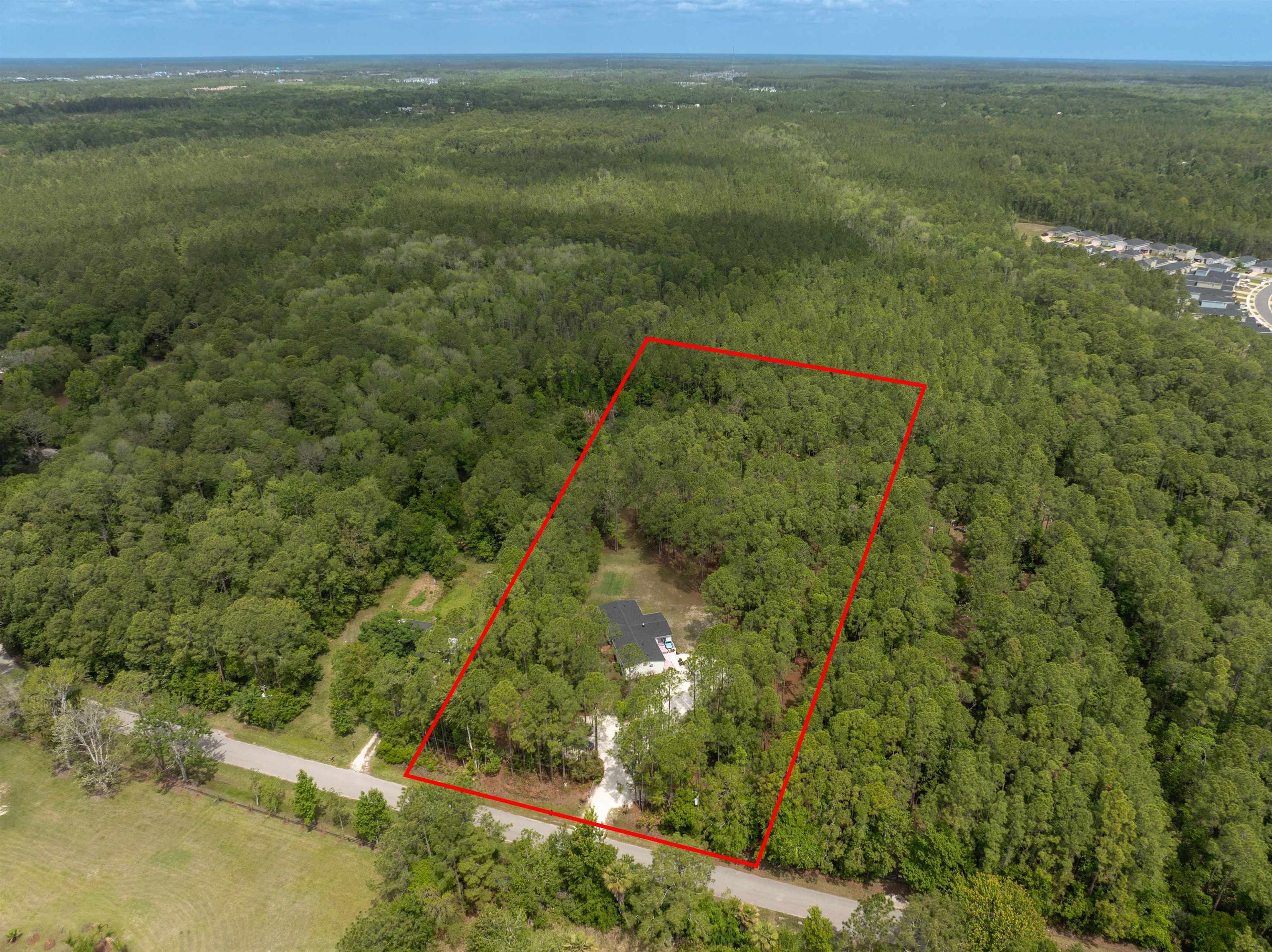 2130 Carter Road St. Augustine, FL 32084 - Photo 62 of 67 Aerial view of property and surrounding area with a forest and property boundaries highlighted