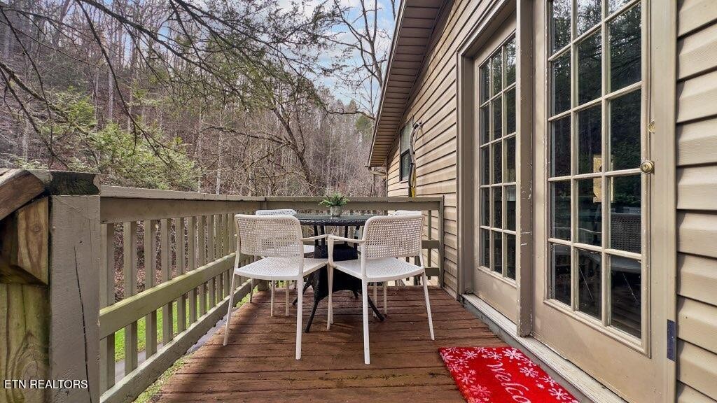 4204 Dellinger Hollow Road, Unit 2 Sevierville, TN 37863 - Photo 3 of 13 a view of a chairs and table on the deck
