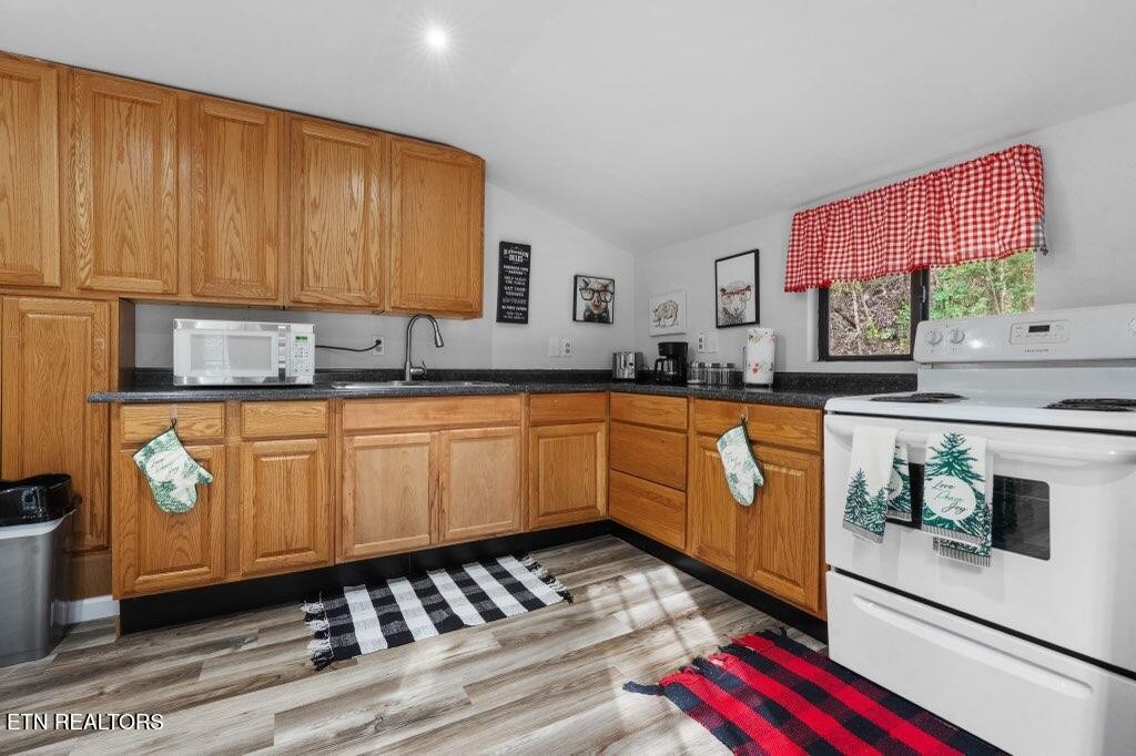 4204 Dellinger Hollow Road, Unit 2 Sevierville, TN 37863 - Photo 5 of 13 a kitchen with granite countertop a sink a stove and cabinets