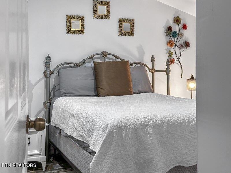 4204 Dellinger Hollow Road, Unit 2 Sevierville, TN 37863 - Photo 8 of 13 a bedroom with a bed and a painting on the wall