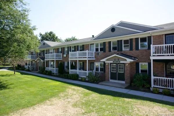 a front view of a house with a yard table and chairs