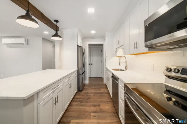 a spacious kitchen with a stove and a refrigerator