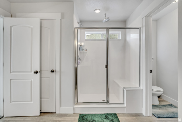 1577 Quailhill Road Saratoga Springs, UT 84045 - Photo 22 of 46 Primary bathroom with a shower stall and light wood-type flooring