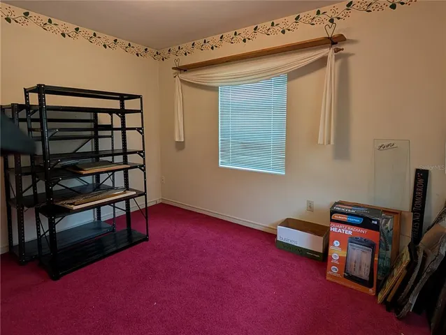 a view of that has a bed and a bookshelf