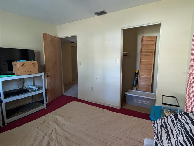 a bedroom with a bed and a mirror