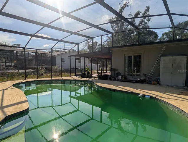a view of a swimming pool with a patio