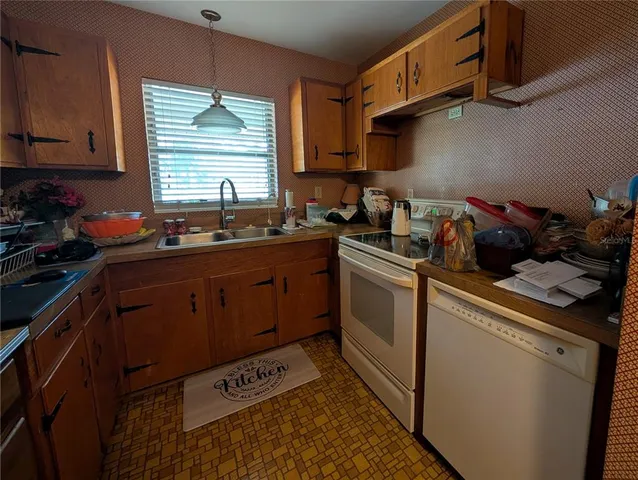 a kitchen with stainless steel appliances a sink stove and cabinets