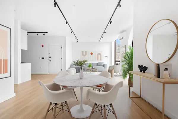 a view of a dining room with furniture and wooden floor