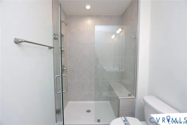 a bathroom with a shower and a toilet