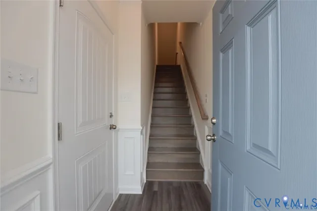a view of a hallway with wooden floor and entryway