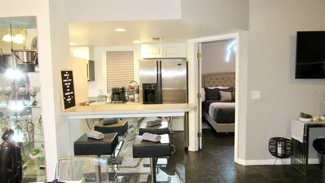 a kitchen with stainless steel appliances kitchen island granite countertop a refrigerator and a stove top oven