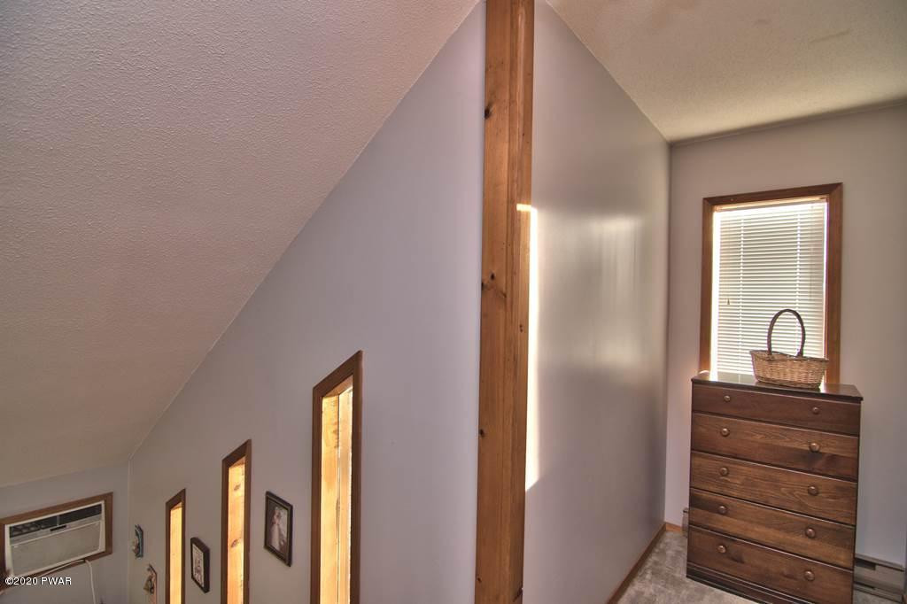 27-2690 Boulder Road Lake Ariel, PA 18436 - Photo 29 of 48 a view of a hallway with a dresser and mirror in a room