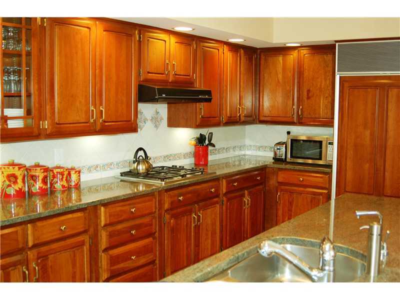 103 Summit Road Riverside, CT 06878 - Photo 4 of 17 a kitchen with granite countertop wooden cabinets a sink and dishwasher