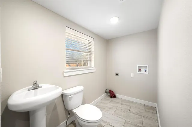 a bathroom with a sink toilet and a mirror