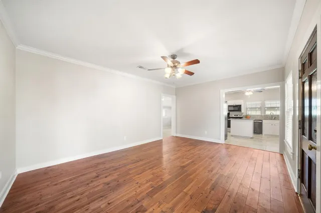 a view of a kitchen with wooden floor and a sink