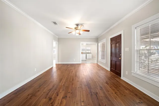 wooden floor in an empty room with a window