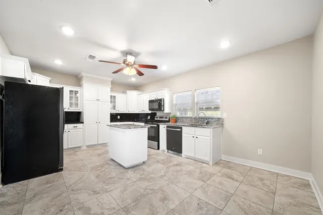 a kitchen with a refrigerator and a sink