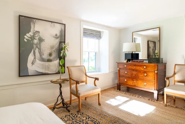 a living room with patio furniture and a potted plant