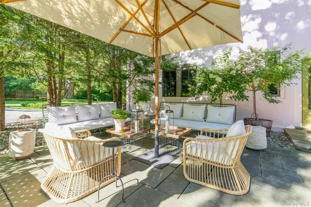 a backyard of a house with table and chairs