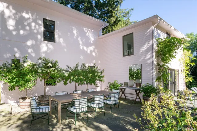 a view of a patio with table and chairs under an umbrella