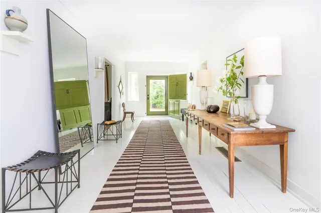 a view of a living room with a table and chairs