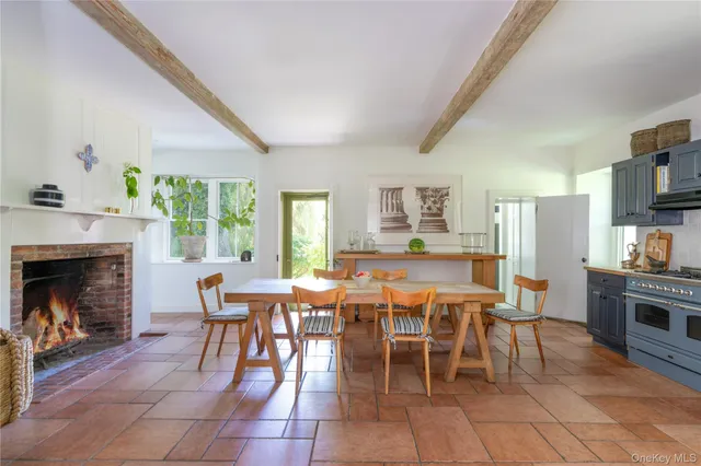 a dining room with furniture a fireplace and wooden floor