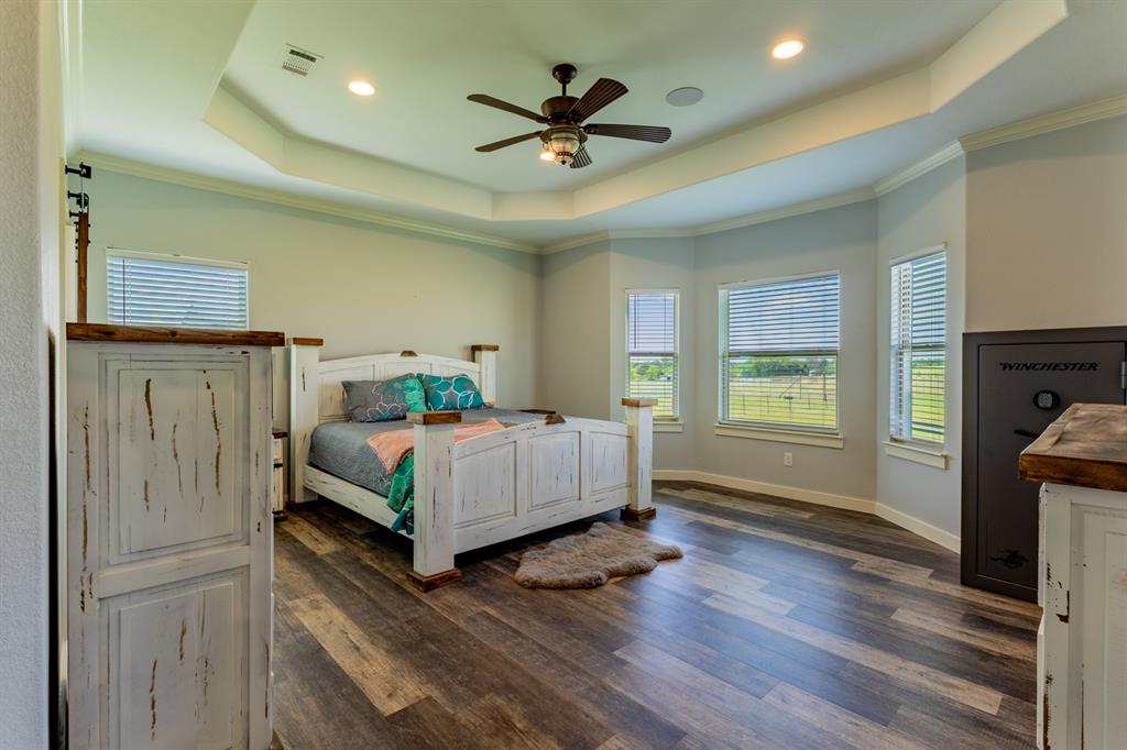 14910 Old Stoney Road Ponder, TX 76259 - Photo 17 of 36 a bedroom with a bed and a ceiling fan