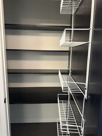 a bathroom with a walk in closet and a shower