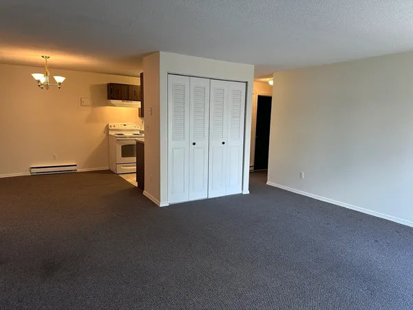 a view of a room with a kitchen