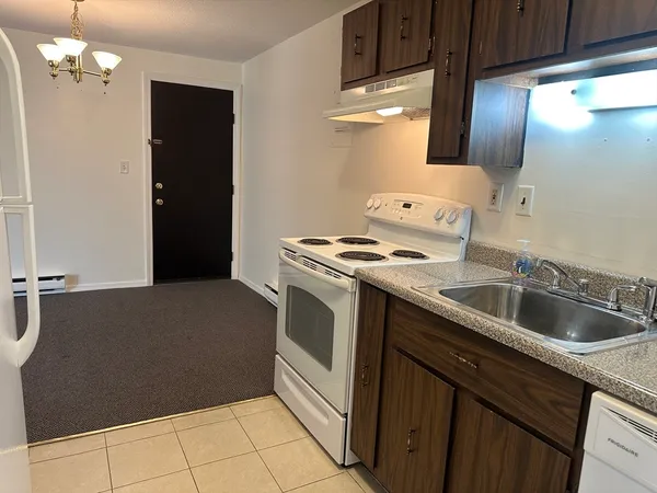 a kitchen with a sink cabinets and utility