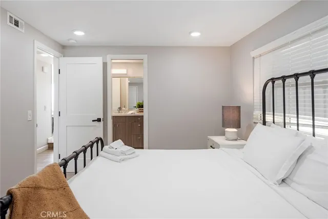 a bedroom with a bed and a desk