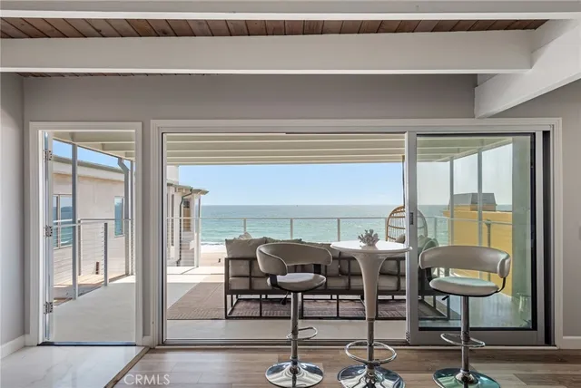 a view of a room that has a table and chairs in it