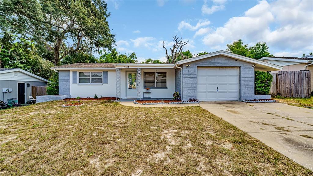9406 Rainbow Lane Port Richey, FL 34668 - Photo 1 of 1 a view of a house with a yard